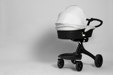 Baby carriage. Modern pram on grey background, space for text