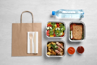 Lunchboxes on white wooden table, flat lay. Healthy food delivery