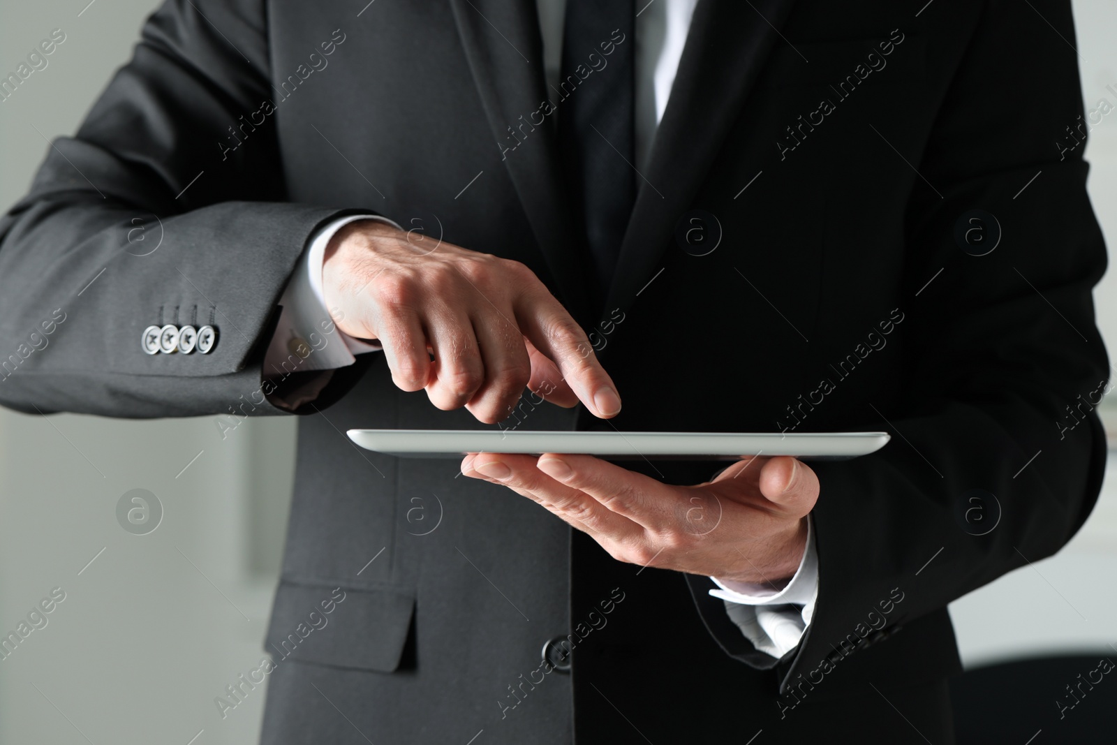 Photo of Closeup view of man using new tablet indoors