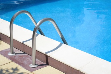 Photo of Swimming pool with metal ladder on sunny day