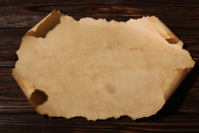 Sheet of old parchment paper on wooden table, above view
