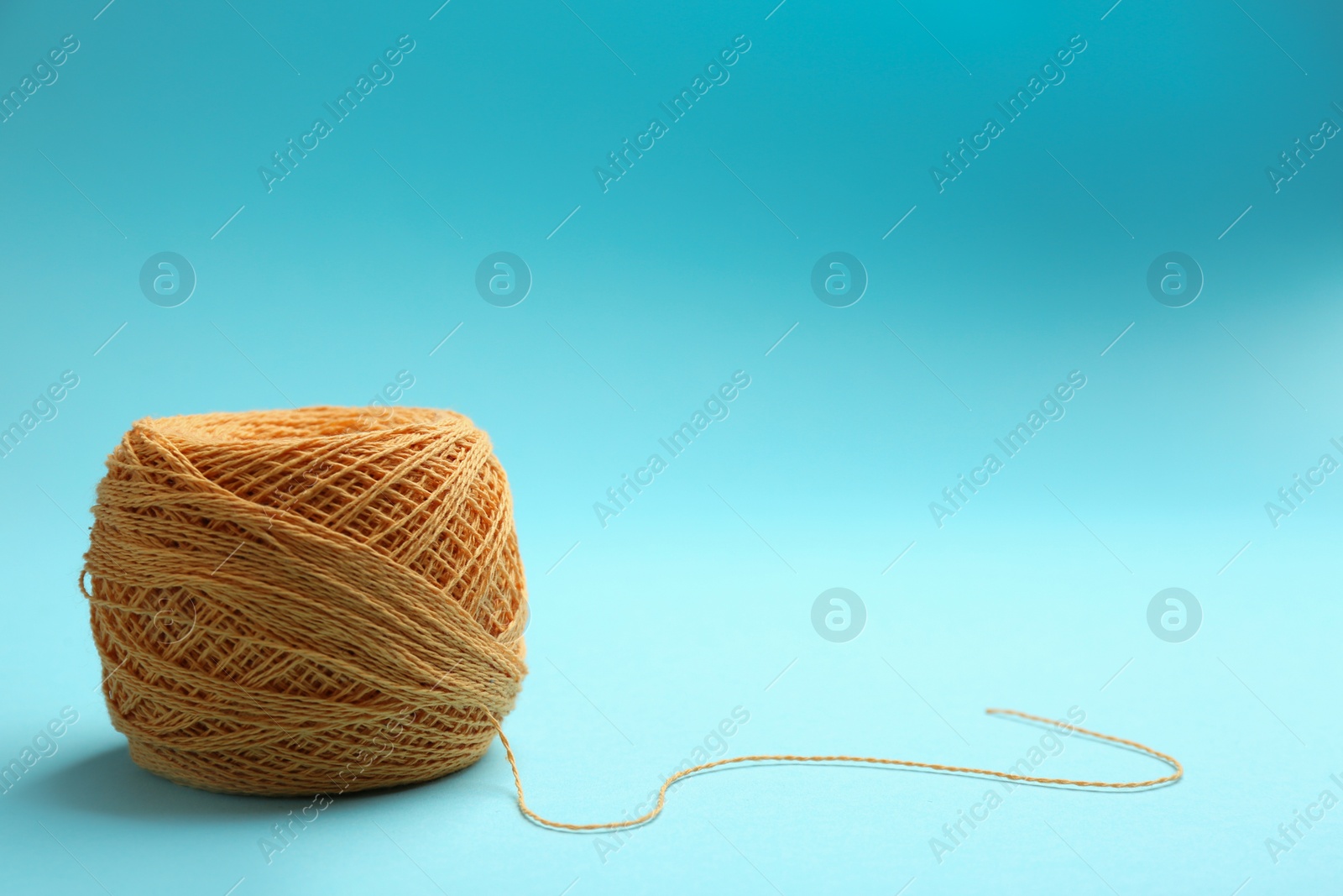 Photo of Clew of knitting threads on color background, space for text. Sewing stuff