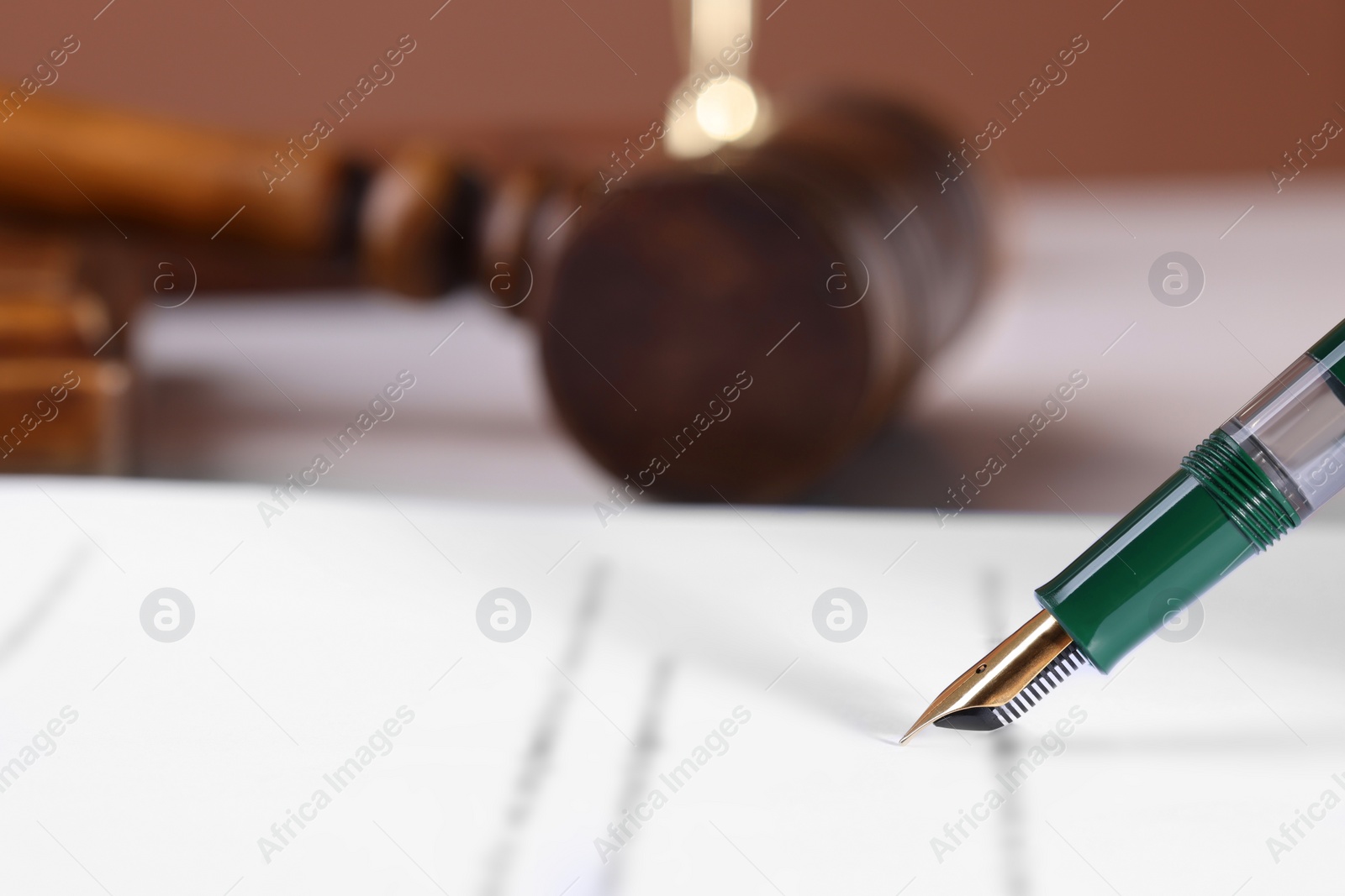 Photo of Writing on document with fountain pen at table, closeup and space for text. Notary contract