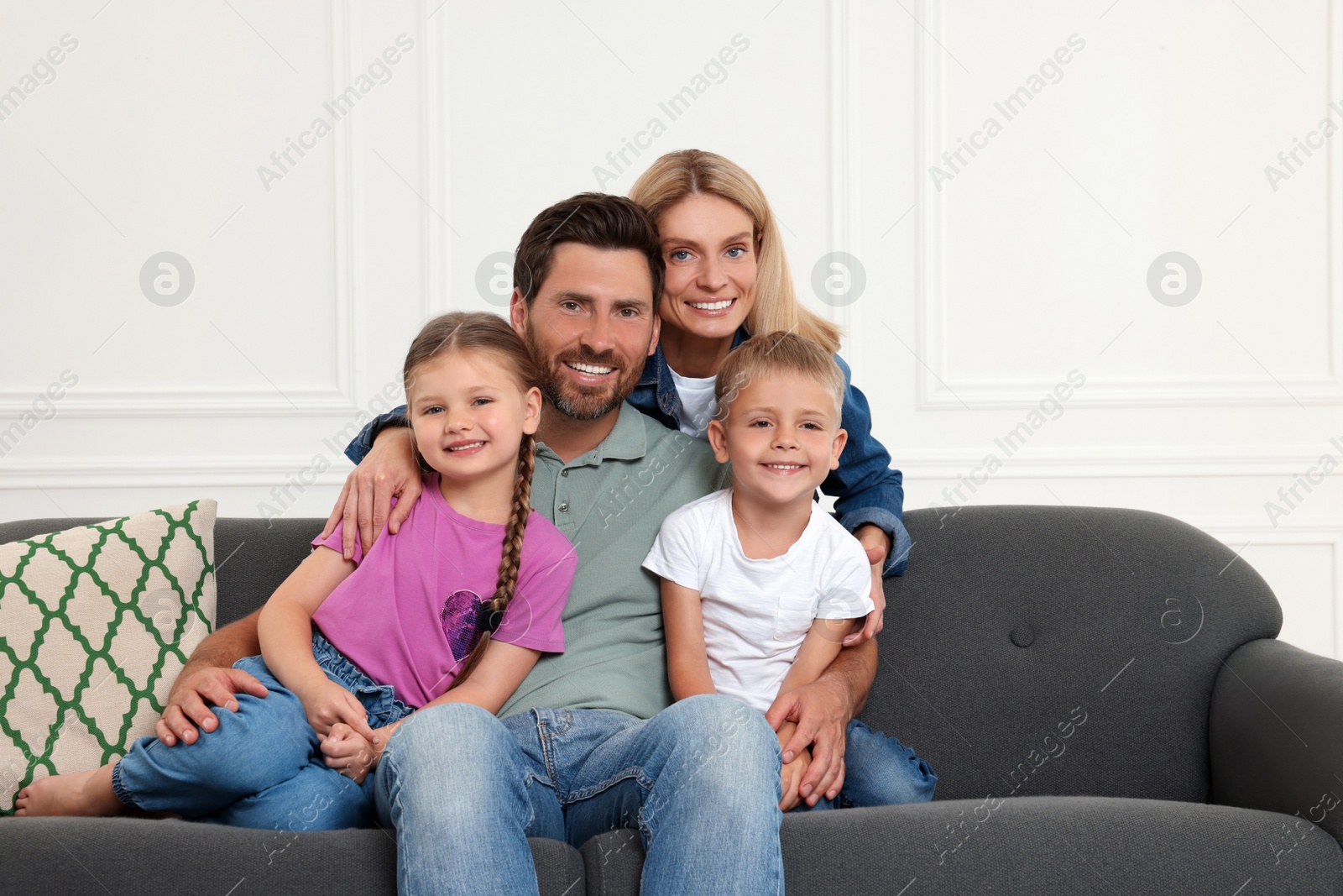 Photo of Portrait of happy family with children on sofa at home