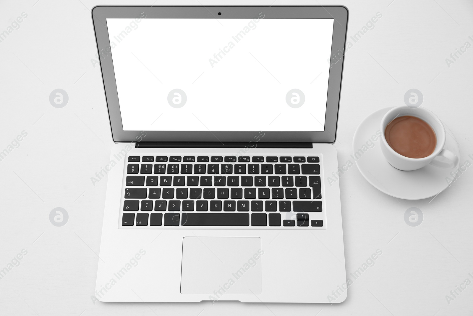 Photo of Comfortable workplace with modern laptop on table. Mockup for design