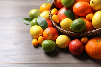 Different ripe citrus fruits on wooden table