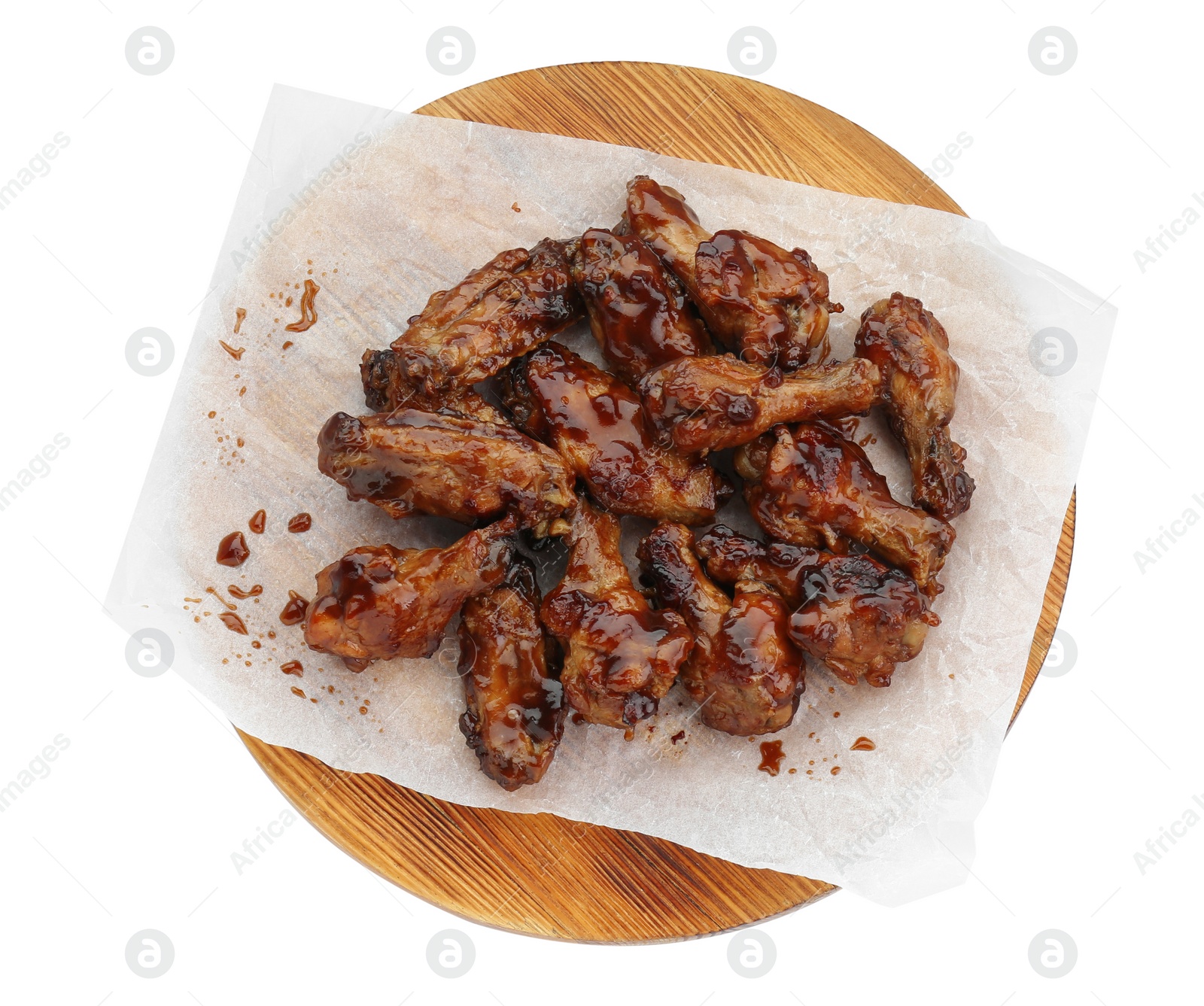 Photo of Board with tasty chicken wings isolated on white, top view