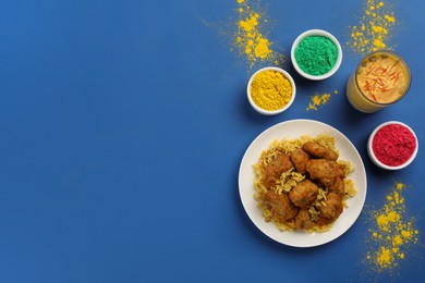 Traditional Indian food and color powders on blue background, flat lay with space for text. Holi festival celebration