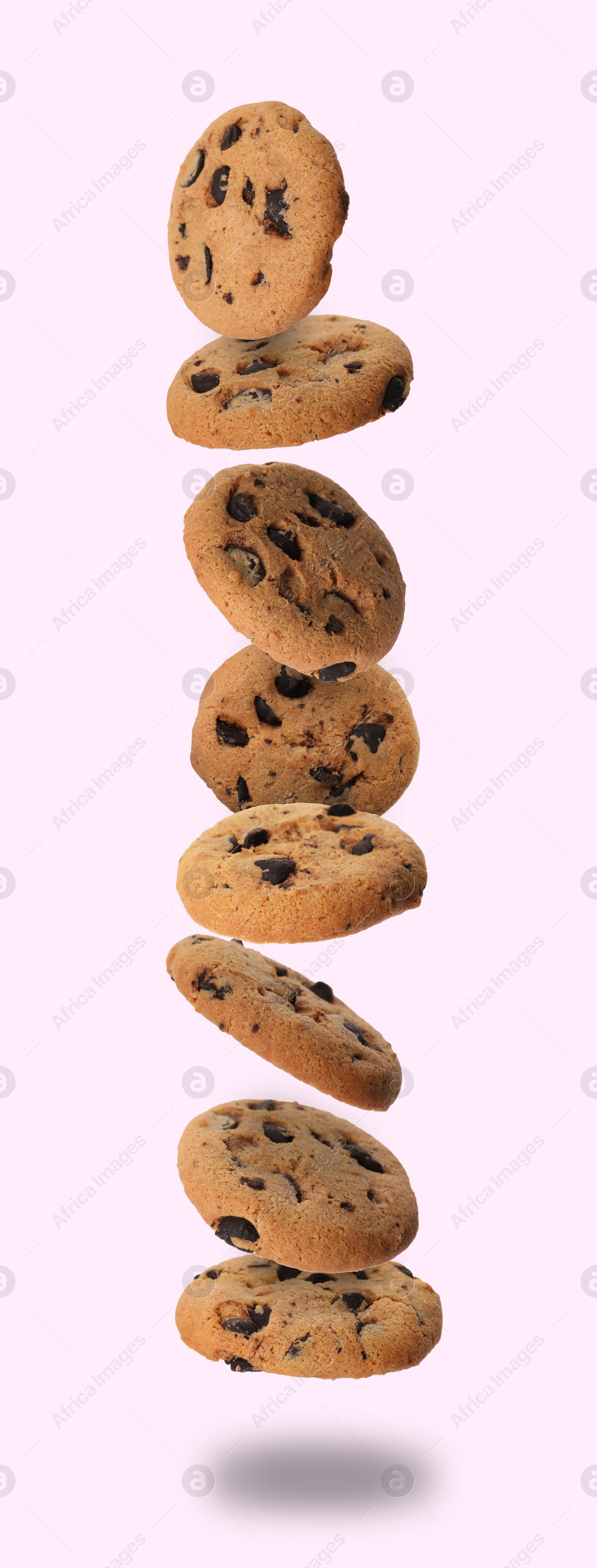 Image of Delicious chocolate chip cookies falling on light background