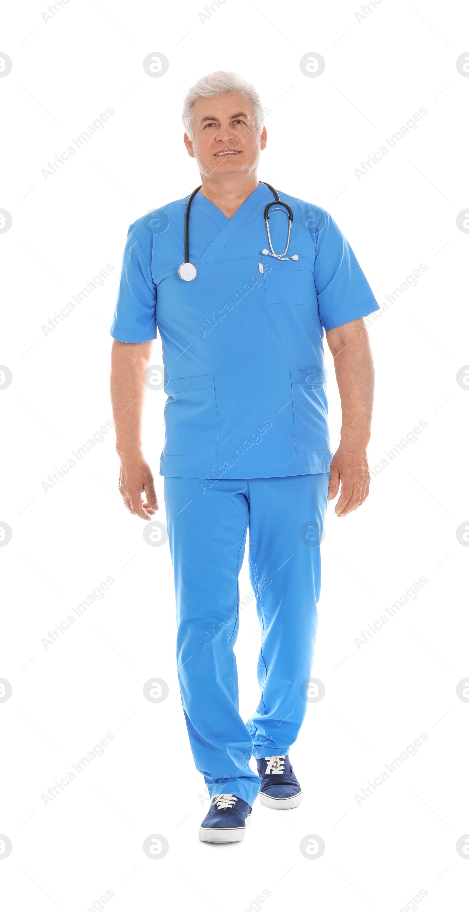 Photo of Full length portrait of male doctor in scrubs with stethoscope isolated on white. Medical staff