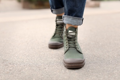 Young woman in comfortable casual shoes walking on street