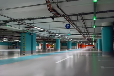 Photo of Empty car parking garage with lighting and columns