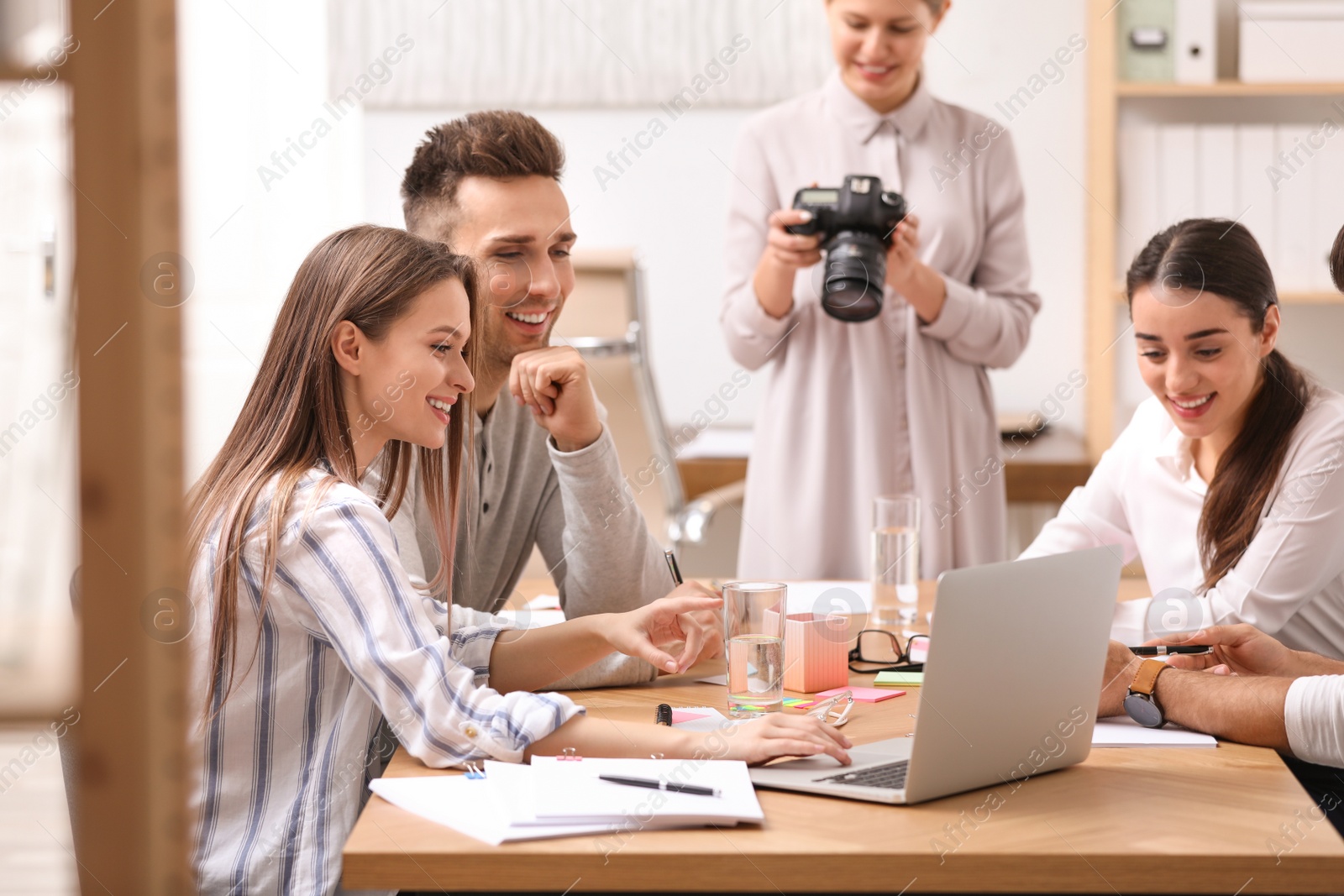 Photo of Team of professional journalists working in office