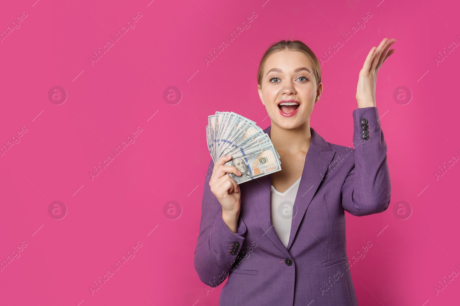 Photo of Portrait of emotional young businesswoman with money on color background. Space for text