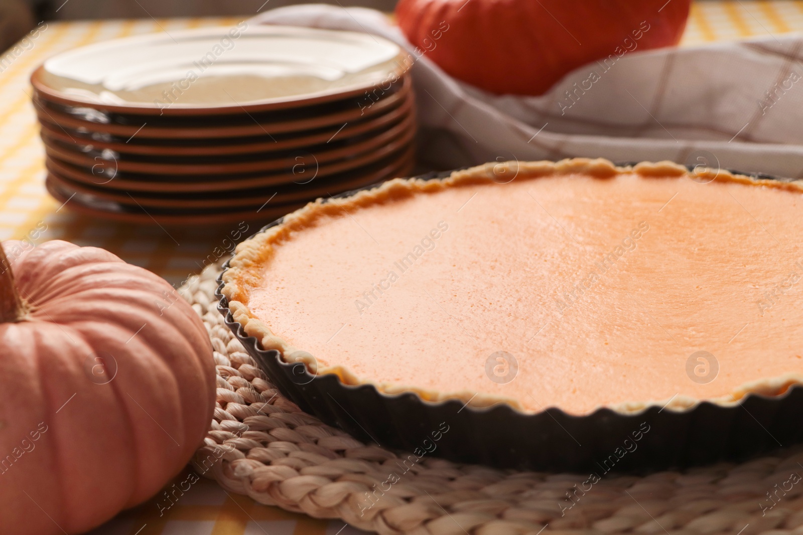 Photo of Delicious homemade pumpkin pie in baking dish on table