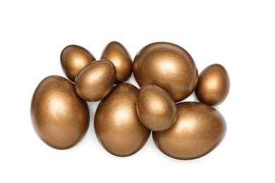 Photo of Many golden eggs on white background, top view