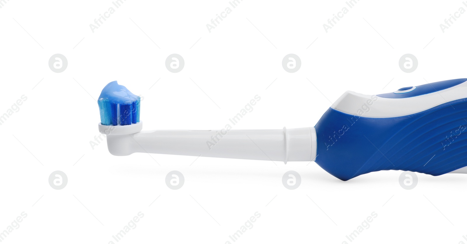 Photo of Electric toothbrush with paste on white background, closeup