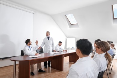 Doctors having discussion on lecture during medical conference