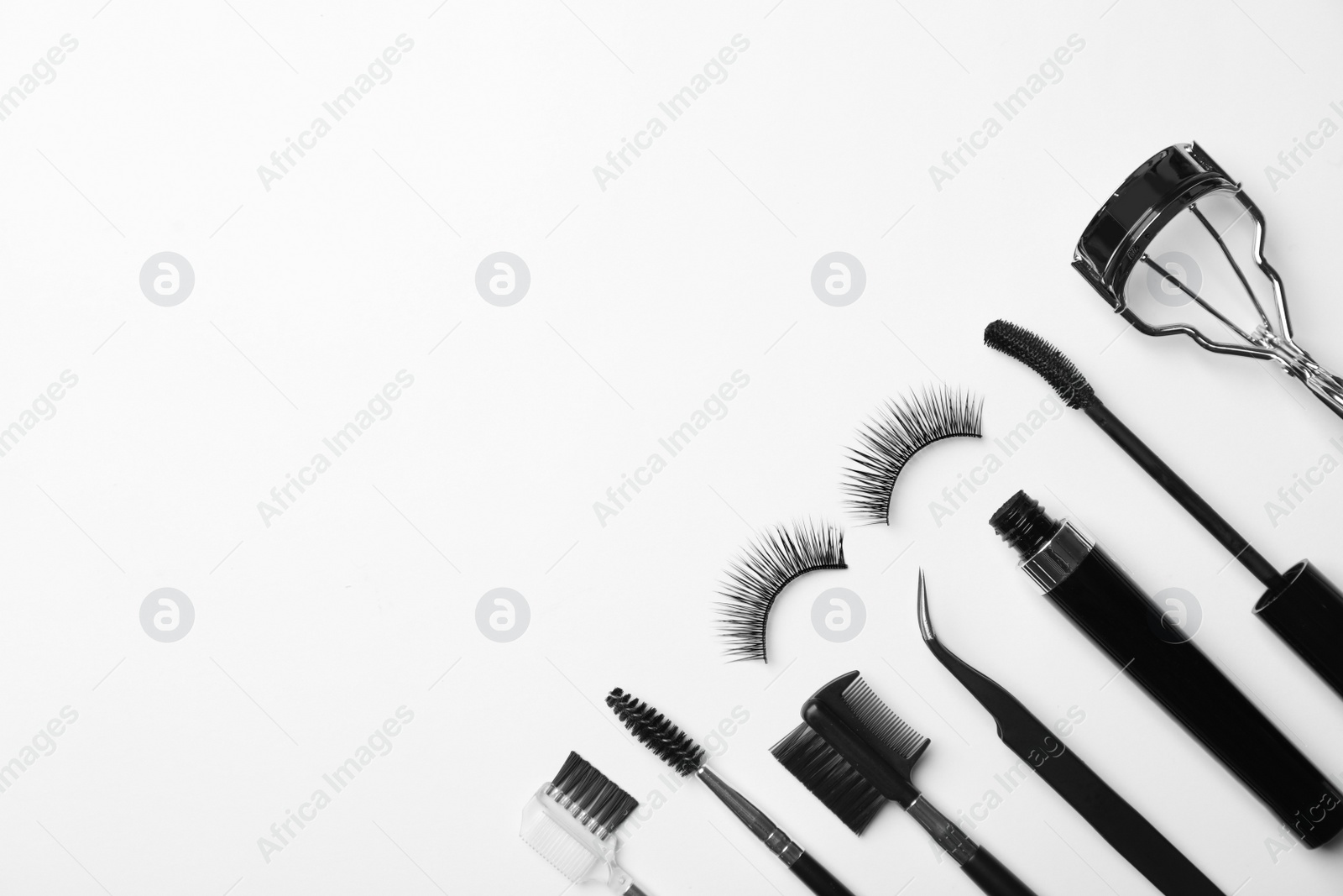 Photo of Flat lay composition of professional makeup tools and false eyelashes on white background