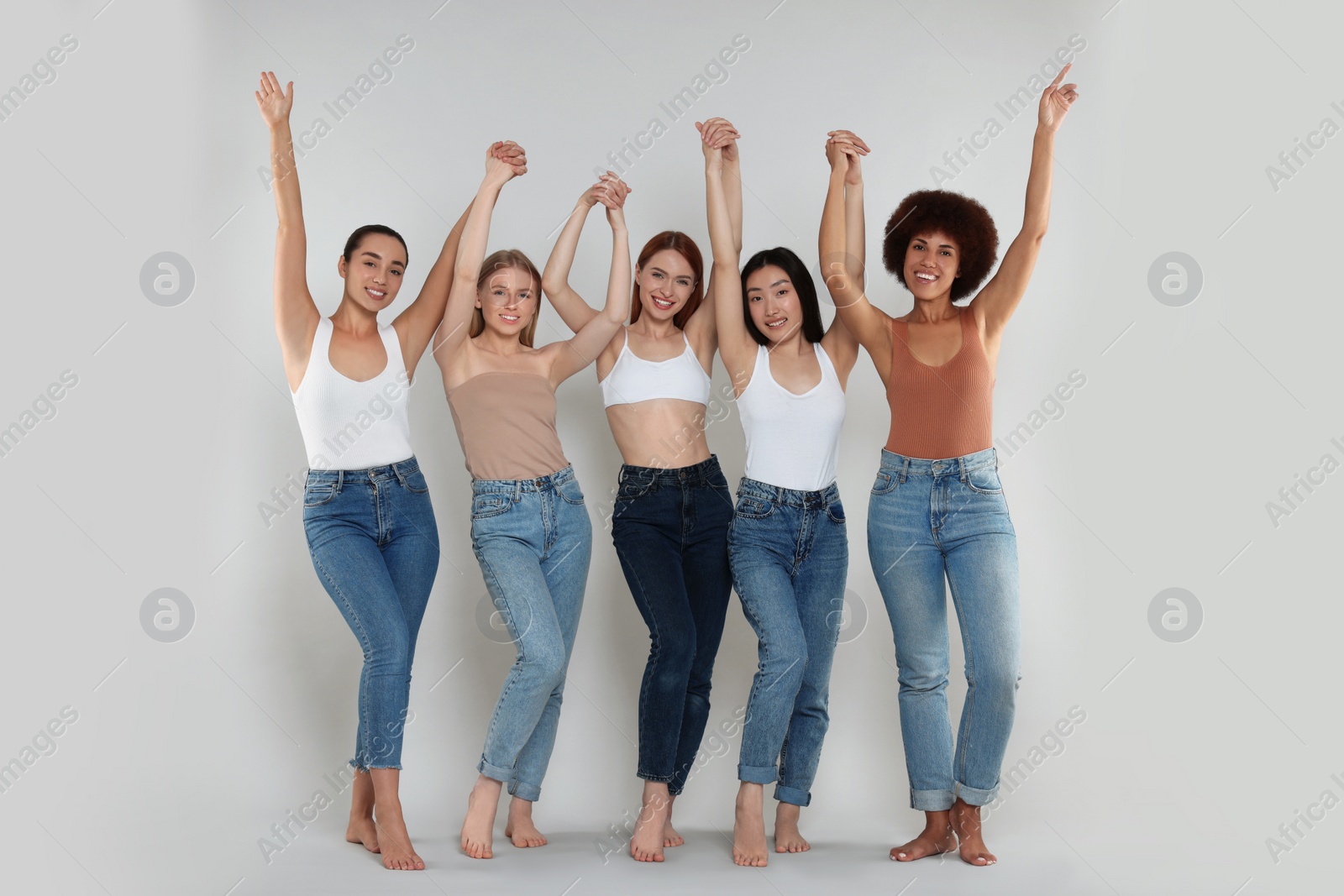 Photo of Group of beautiful young women on light grey background