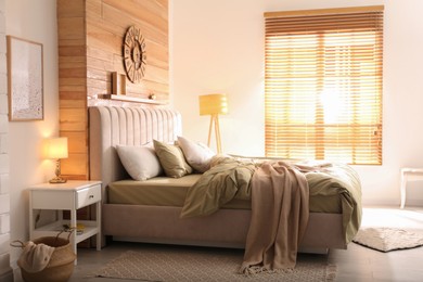 Comfortable bed with new pistachio linens in modern room interior