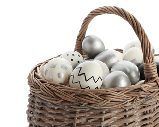 Basket with painted Easter eggs on white background, space for text