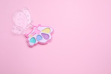 Photo of Decorative cosmetics for kids. Eye shadow palette on pink background, top view. Space for text