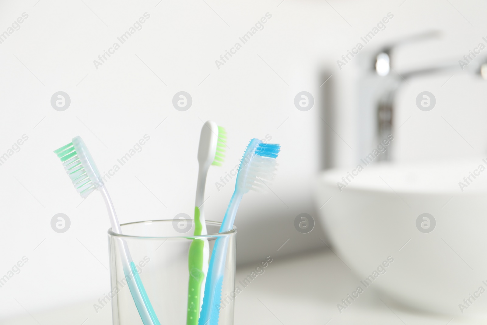 Photo of Plastic toothbrushes on blurred background,, closeup. Space for text