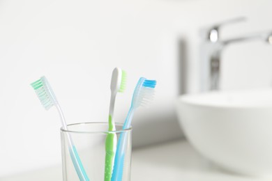 Photo of Plastic toothbrushes on blurred background,, closeup. Space for text