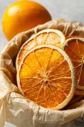 Many dry orange slices on table, closeup