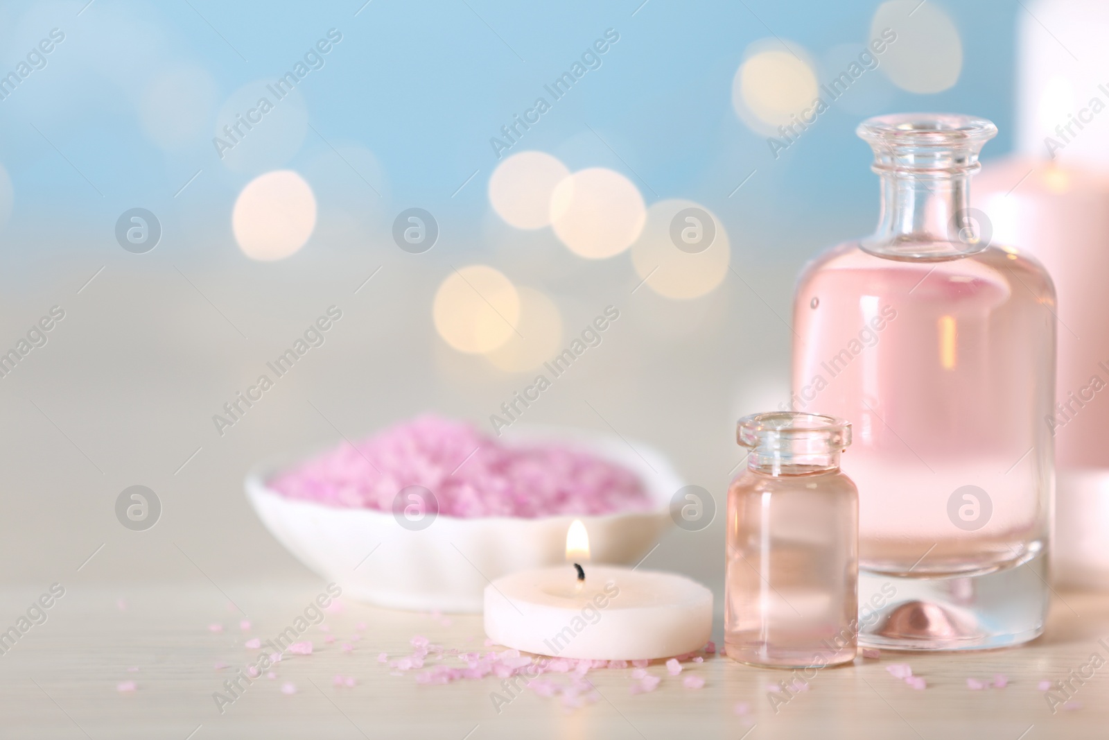 Photo of Beautiful spa composition with essential oil and candle on table, closeup. Space for text