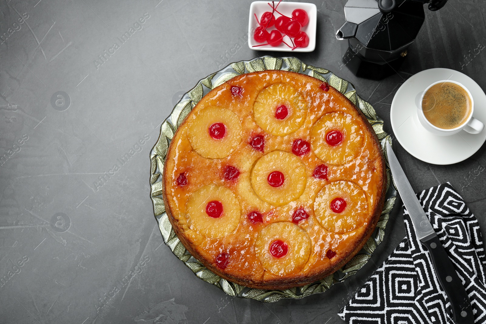 Photo of Flat lay composition with tasty pineapple cake on grey textured table. Space for text