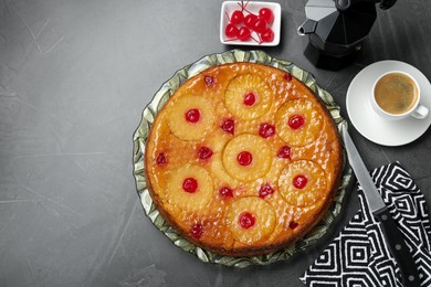 Photo of Flat lay composition with tasty pineapple cake on grey textured table. Space for text