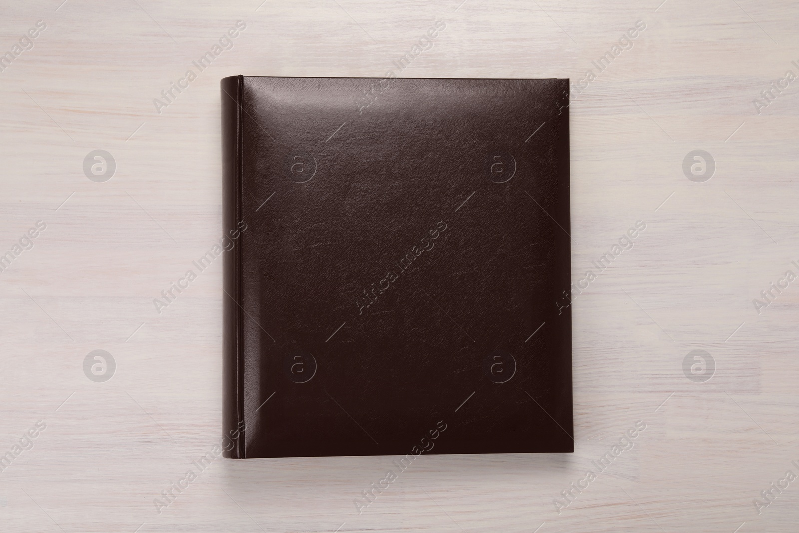 Photo of One photo album on wooden table, top view