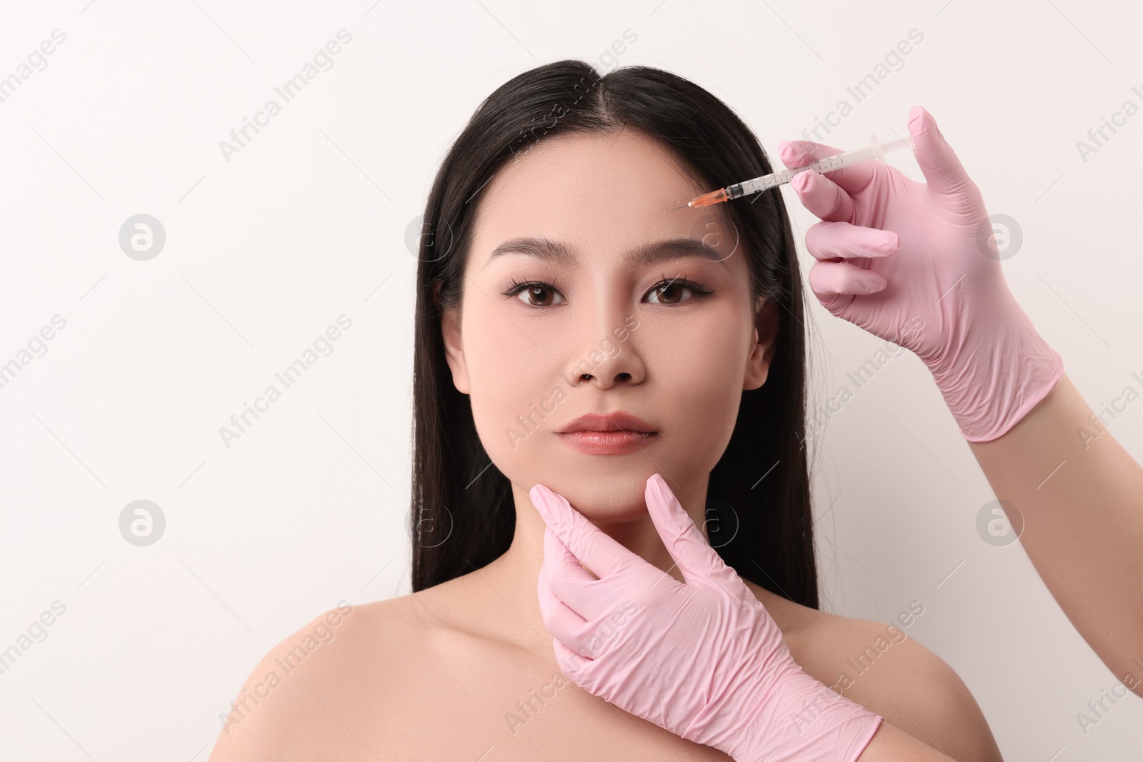 Photo of Woman getting facial injection on white background