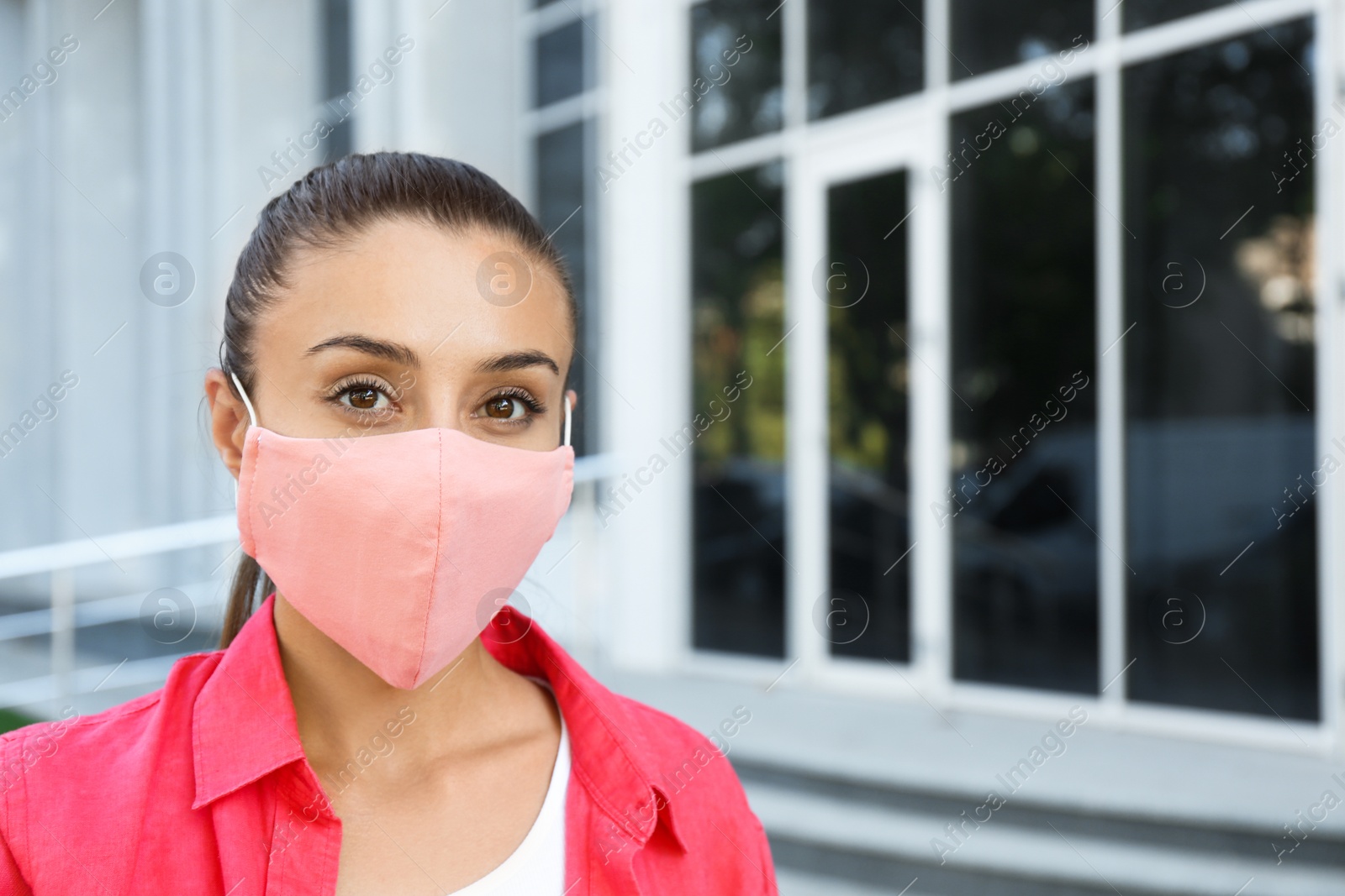 Photo of Woman wearing handmade cloth mask outdoors, space for text. Personal protective equipment during COVID-19 pandemic