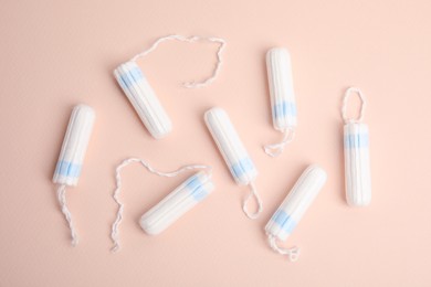 Photo of Tampons on beige background, flat lay. Menstrual hygiene product