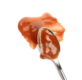 Photo of Spoon and strokes of caramel sauce isolated on white, top view