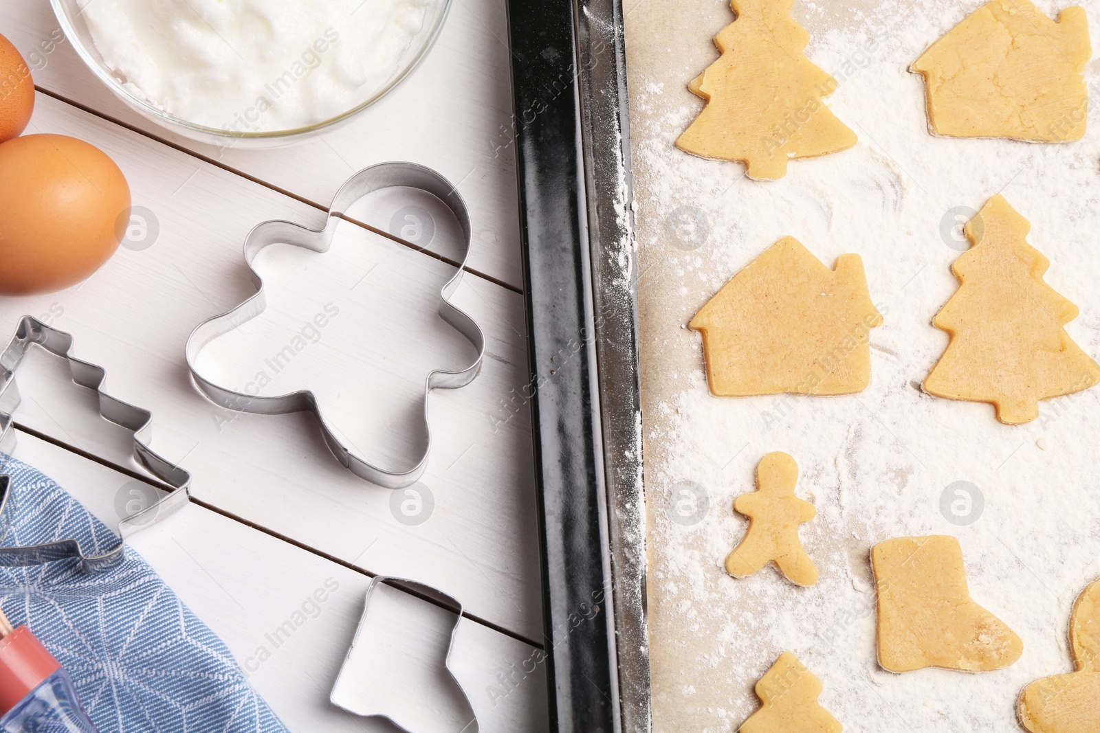 Photo of Making Christmas cookies. Flat lay composition with raw dough and ingredients on white wooden table