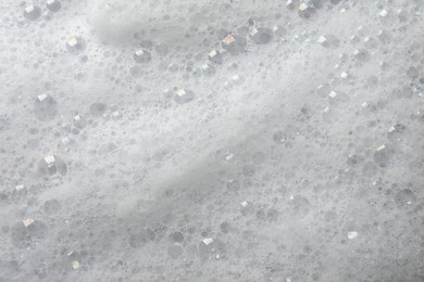 Fluffy soap foam as background, closeup view