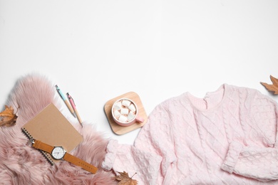 Flat lay composition with soft knitted sweater on white background