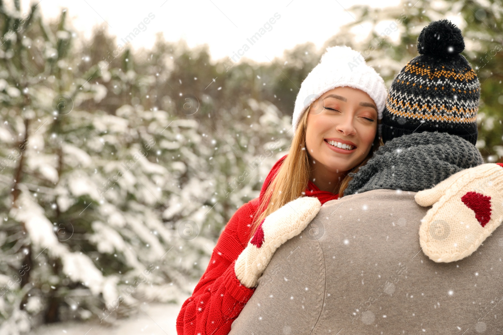 Photo of Beautiful happy couple in snowy forest on winter day