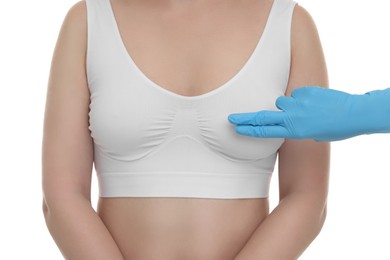 Mammologist checking woman's breast on white background, closeup