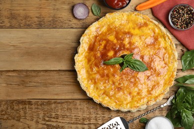 Photo of Delicious pie with minced meat on wooden table, flat lay. Space for text