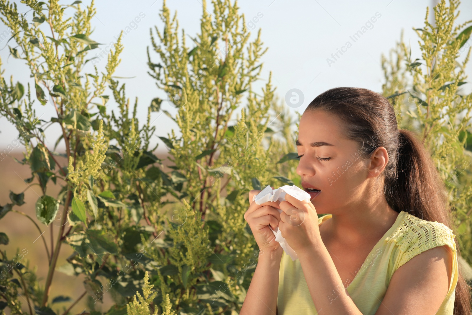 Photo of Young woman suffering from ragweed allergy outdoors