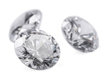 Photo of Three beautiful shiny diamonds isolated on white