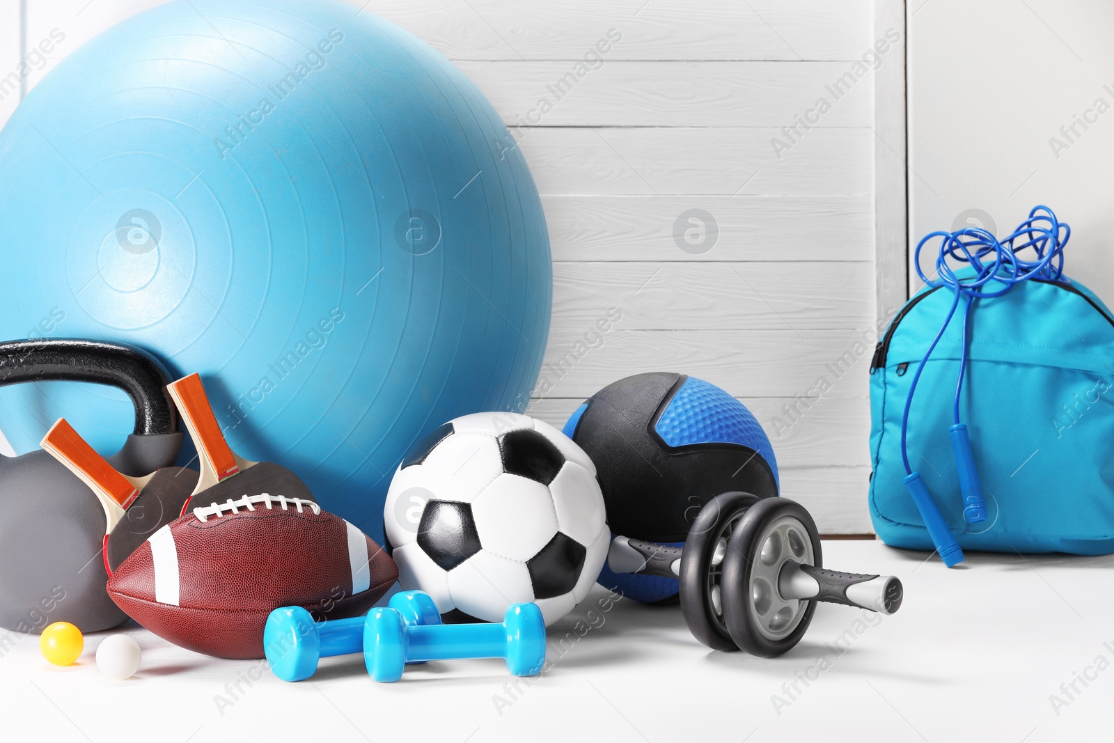 Photo of Many different sports equipment on white table