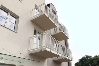 Photo of Exterior of beautiful building with empty balconies, low angle view