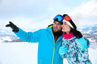 Photo of Young couple at mountain resort. Winter vacation