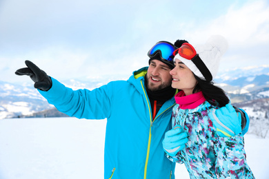 Young couple at mountain resort. Winter vacation